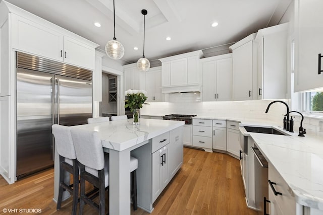 kitchen featuring tasteful backsplash, light wood-type flooring, stainless steel appliances, white cabinetry, and recessed lighting