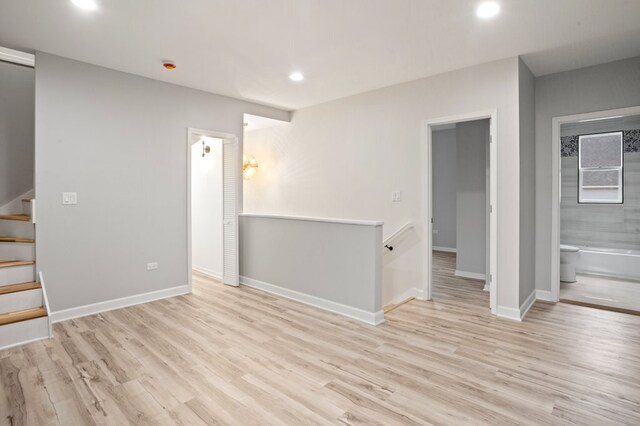 interior space featuring baseboards, recessed lighting, and wood finished floors