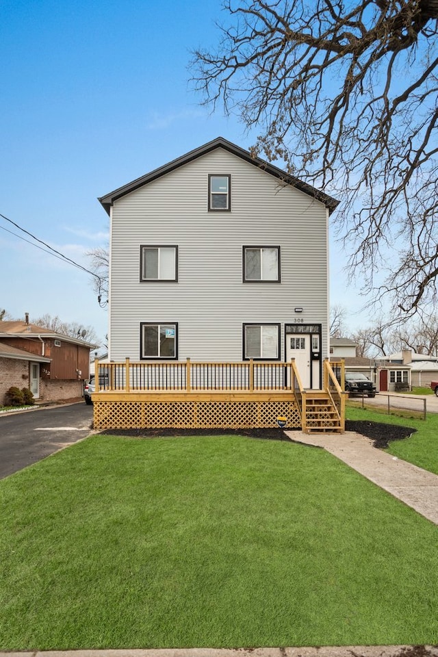 back of house featuring a yard, driveway, and a deck