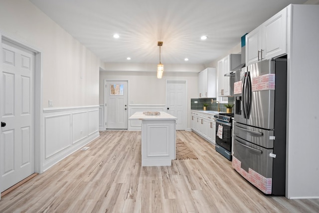 kitchen featuring stainless steel fridge with ice dispenser, electric range, white cabinets, a center island, and light countertops