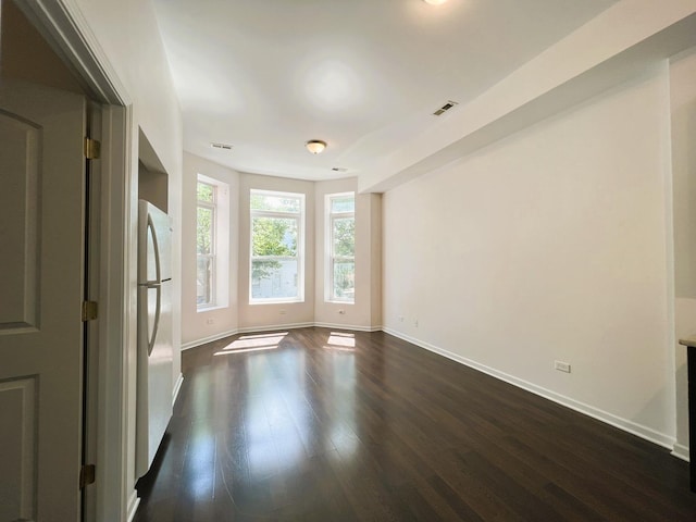 3436 S Wallace St, Chicago, IL 60616 - unfurnished room featuring baseboards, dark wood-style floors, and visible vents