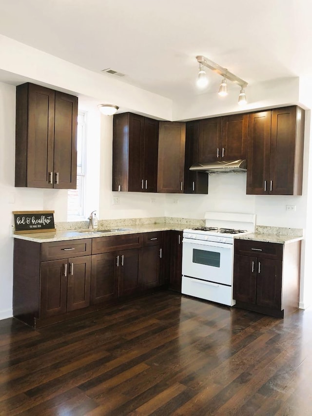3436 S Wallace St, Chicago, IL 60616 - kitchen with white range with gas stovetop, dark wood finished floors, a sink, and dark brown cabinetry