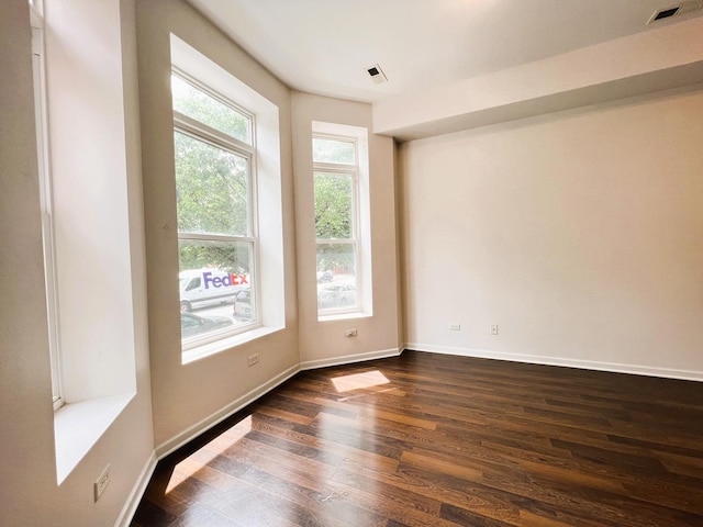 3436 S Wallace St, Chicago, IL 60616 - spare room with baseboards, dark wood-style flooring, and visible vents