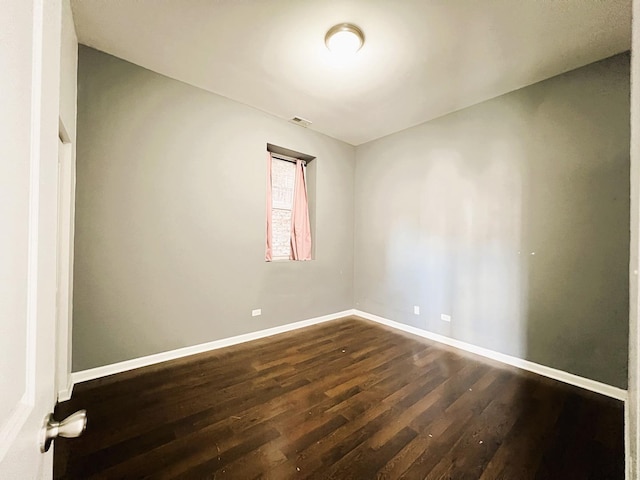 3436 S Wallace St, Chicago, IL 60616 - spare room featuring visible vents, baseboards, and dark wood-style floors