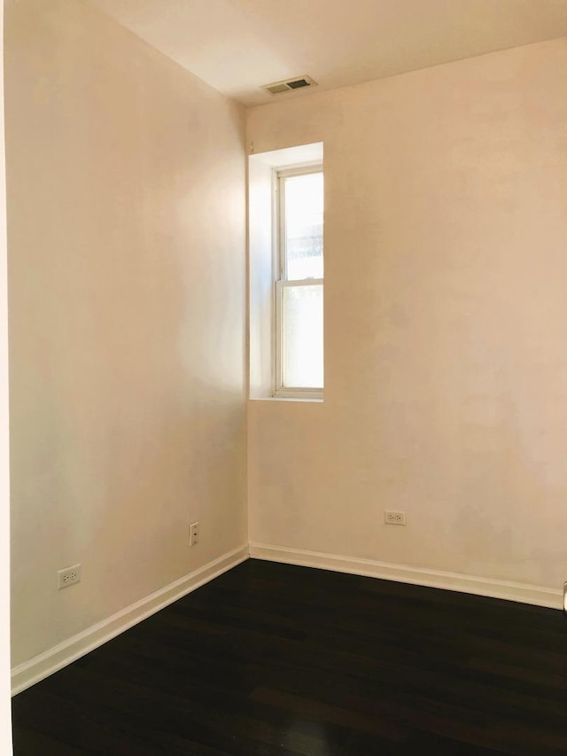 3436 S Wallace St, Chicago, IL 60616 - spare room with baseboards, visible vents, and dark wood-style floors