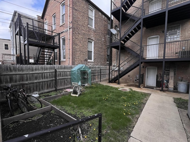3436 S Wallace St, Chicago, IL 60616 - view of yard with stairway and a fenced backyard