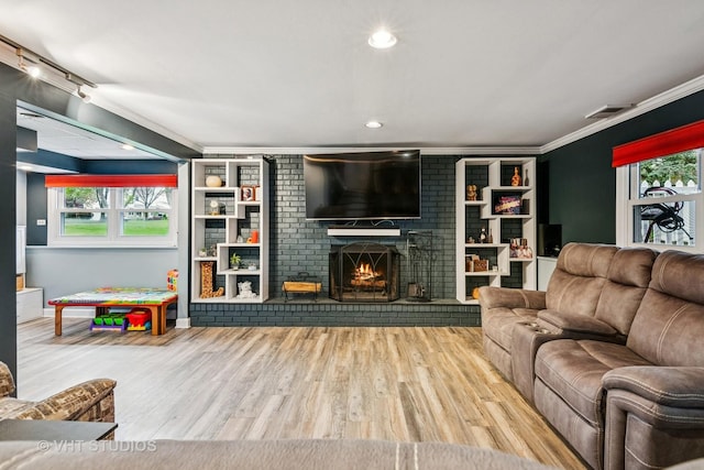 403 E Amherst St, Palatine, IL 60074 - living room featuring a brick fireplace, ornamental molding, wood finished floors, and plenty of natural light