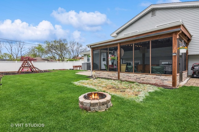 403 E Amherst St, Palatine, IL 60074 - rear view of property featuring a fenced backyard, a yard, a sunroom, and an outdoor fire pit