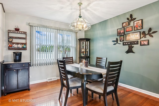 403 E Amherst St, Palatine, IL 60074 - dining room featuring a chandelier, baseboards, visible vents, and wood finished floors