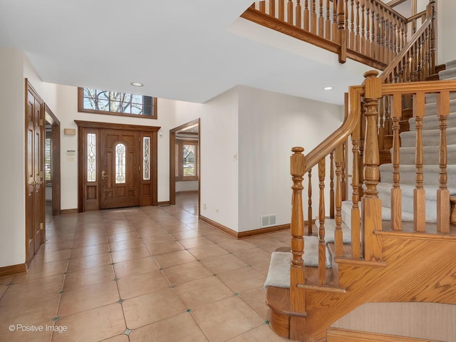 14320 Claridge Ct, Orland Park, IL 60462 - entrance foyer with a high ceiling, baseboards, visible vents, and stairs