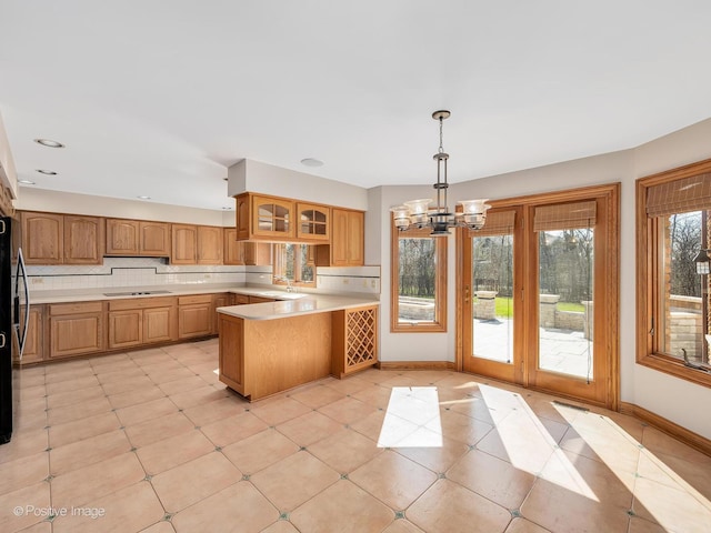 14320 Claridge Ct, Orland Park, IL 60462 - kitchen with tasteful backsplash, a notable chandelier, a peninsula, light countertops, and black appliances