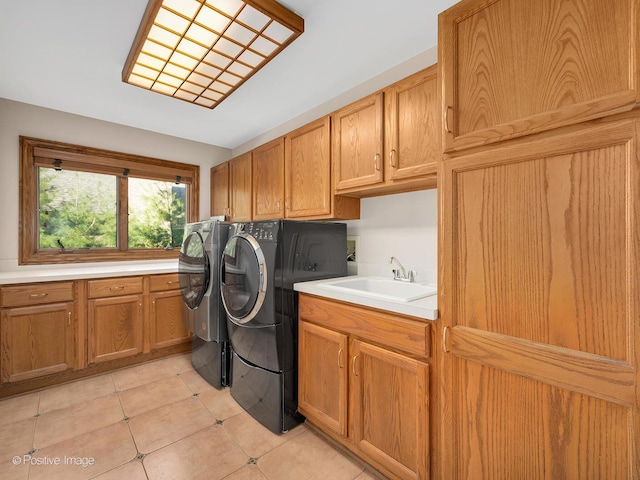 14320 Claridge Ct, Orland Park, IL 60462 - clothes washing area with washing machine and clothes dryer, a sink, cabinet space, and light tile patterned floors