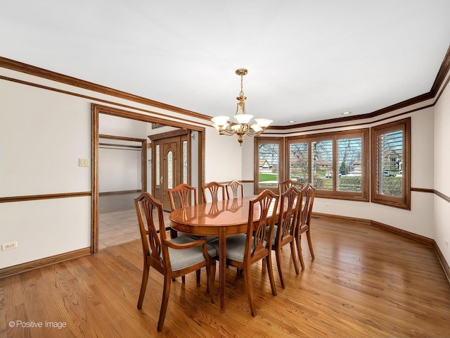 14320 Claridge Ct, Orland Park, IL 60462 - dining area with a chandelier, light wood-style flooring, baseboards, and ornamental molding