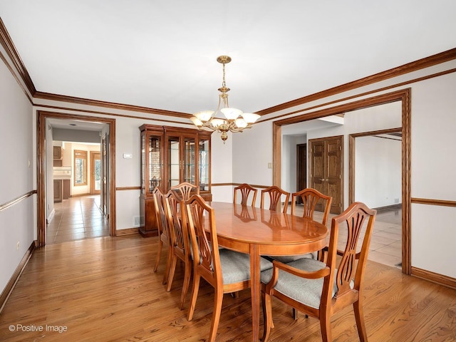 14320 Claridge Ct, Orland Park, IL 60462 - dining room featuring a chandelier, light wood-style floors, baseboards, and ornamental molding