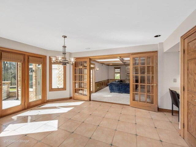 14320 Claridge Ct, Orland Park, IL 60462 - unfurnished dining area with a chandelier, french doors, and baseboards