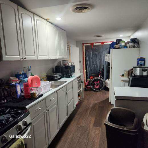 327 W Division, Amboy, IL 61310 - kitchen with white cabinets, light countertops, dark wood finished floors, and visible vents
