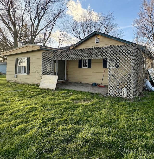 327 W Division, Amboy, IL 61310 - rear view of house featuring a yard and a patio area