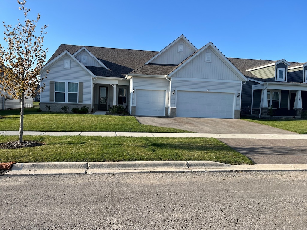 3156 Bellwether Dr, Aurora, IL 60503 - view of front of house with board and batten siding, roof with shingles, a front yard, a garage, and concrete driveway