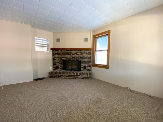 1657 Clay St, Woodstock, IL 60098 - unfurnished living room featuring carpet flooring and a brick fireplace