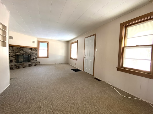 1657 Clay St, Woodstock, IL 60098 - unfurnished living room with carpet and a brick fireplace