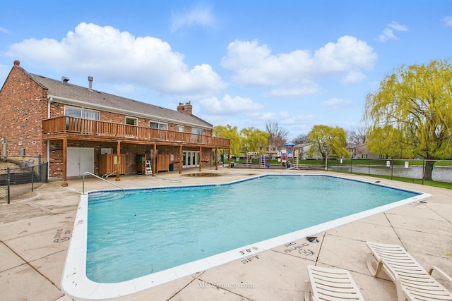 community pool featuring fence and a patio area