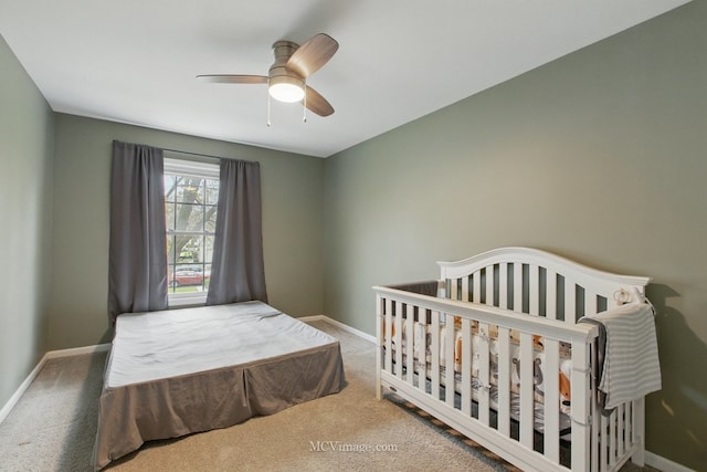 bedroom with carpet, a ceiling fan, and baseboards