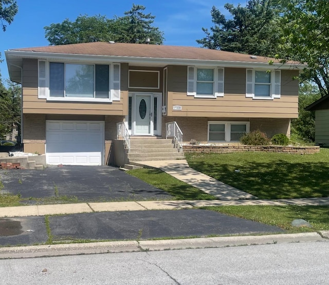 17005 Elm Dr, Hazel Crest, IL 60429 - split foyer home featuring an attached garage, asphalt driveway, entry steps, a front lawn, and brick siding