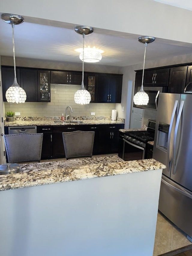 17005 Elm Dr, Hazel Crest, IL 60429 - kitchen with appliances with stainless steel finishes, tasteful backsplash, light stone countertops, and dark cabinetry