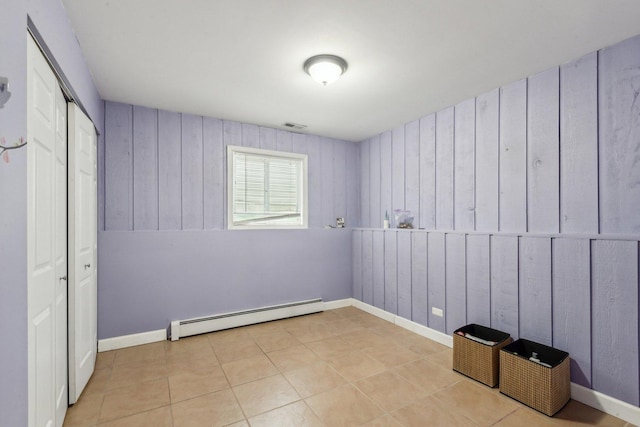 unfurnished bedroom with a baseboard radiator and a closet