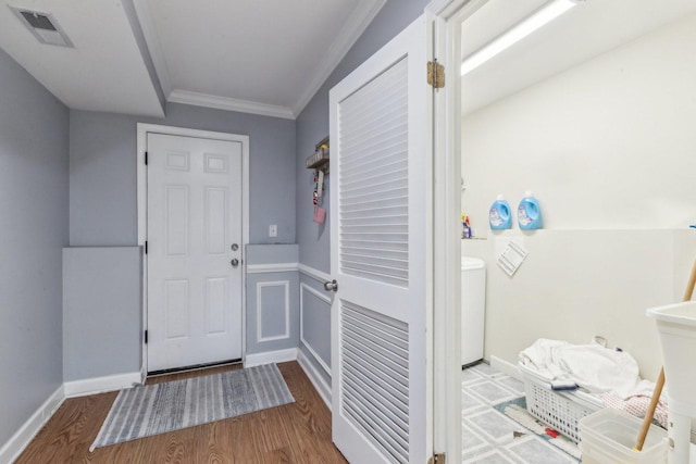 entryway featuring crown molding, wood finished floors, and washer / dryer
