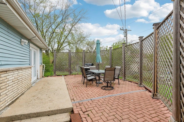 view of patio with outdoor dining space and a fenced backyard