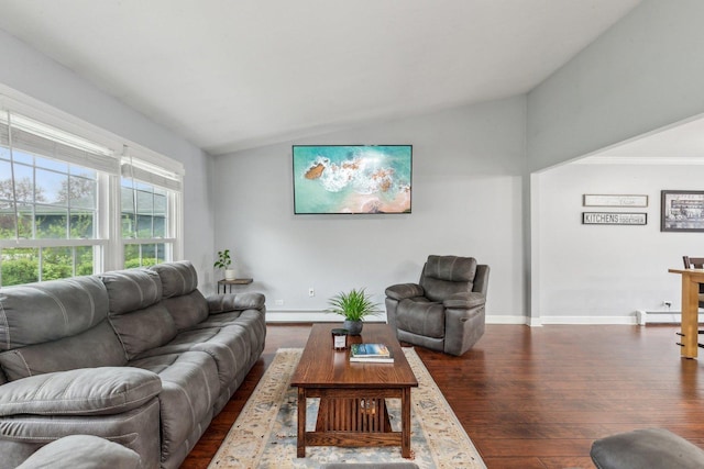 living room with vaulted ceiling, dark wood finished floors, baseboard heating, and baseboards