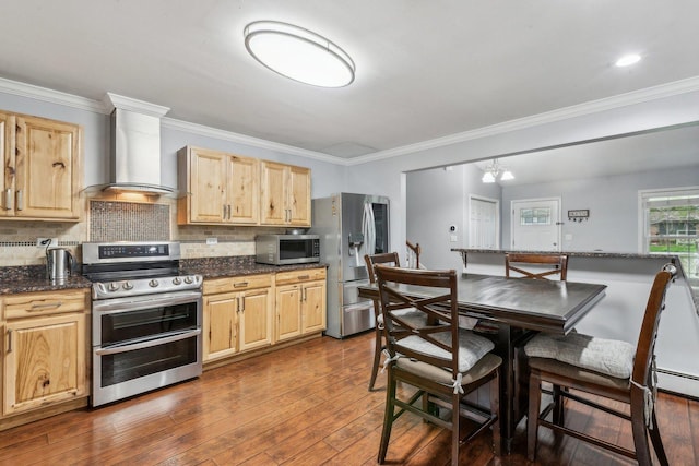 kitchen with stainless steel appliances, wall chimney range hood, light brown cabinets, and ornamental molding