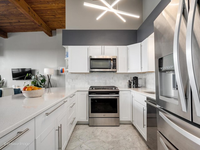 3323 N Paulina St Unit 5F, Chicago, IL 60657 - kitchen with appliances with stainless steel finishes, white cabinetry, decorative backsplash, wood ceiling, and beamed ceiling