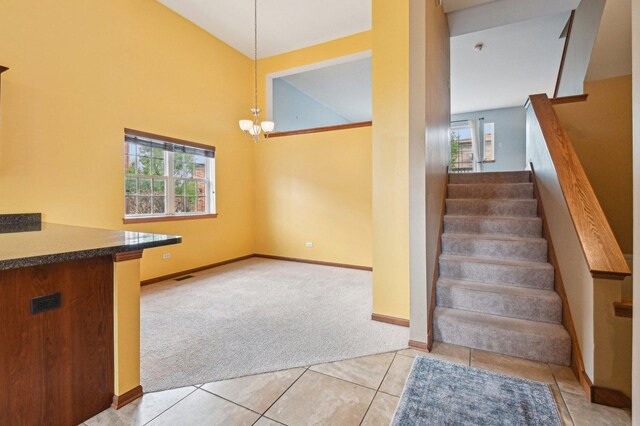 6422 W 65th St, Chicago, IL 60638 - stairway with carpet flooring, an inviting chandelier, tile patterned floors, baseboards, and lofted ceiling