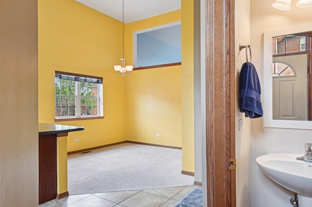 6422 W 65th St, Chicago, IL 60638 - bathroom with a sink, tile patterned floors, a chandelier, baseboards, and visible vents