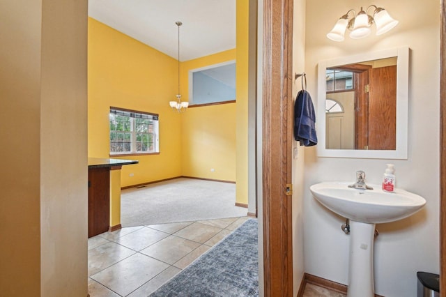 6422 W 65th St, Chicago, IL 60638 - bathroom featuring an inviting chandelier, baseboards, and tile patterned flooring