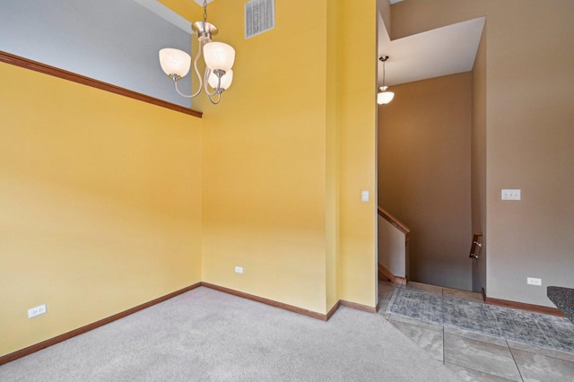 6422 W 65th St, Chicago, IL 60638 - carpeted empty room with visible vents, baseboards, and a notable chandelier