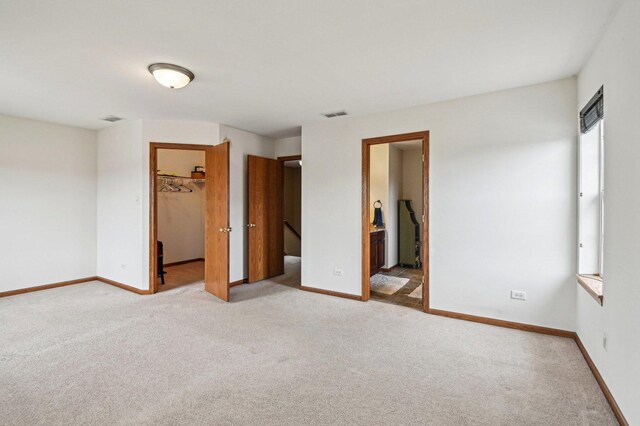 6422 W 65th St, Chicago, IL 60638 - unfurnished bedroom with light colored carpet, baseboards, a walk in closet, and a closet