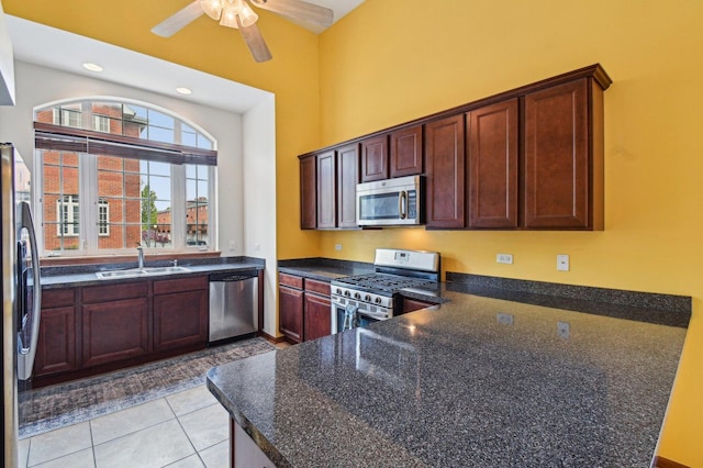 6422 W 65th St, Chicago, IL 60638 - kitchen with a ceiling fan, appliances with stainless steel finishes, a sink, a peninsula, and light tile patterned flooring
