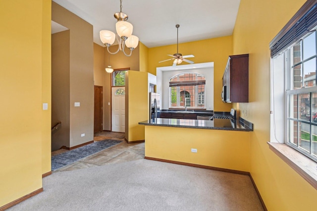 6422 W 65th St, Chicago, IL 60638 - kitchen featuring light carpet, a sink, a peninsula, baseboards, and stainless steel appliances