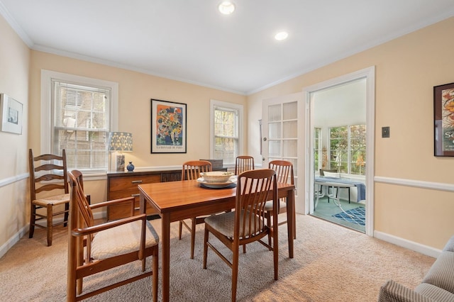 dining space featuring recessed lighting, baseboards, ornamental molding, and light carpet