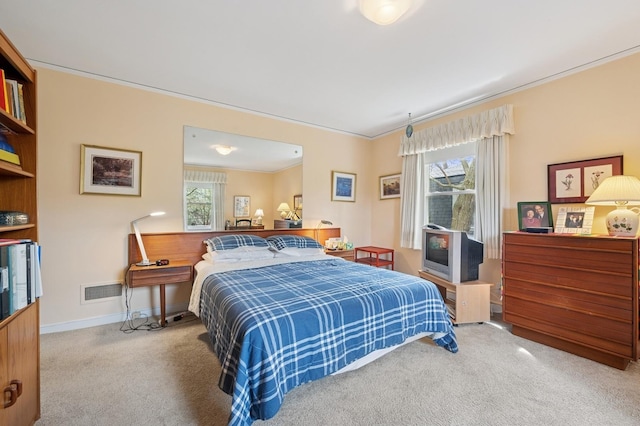 bedroom with carpet floors, crown molding, and multiple windows