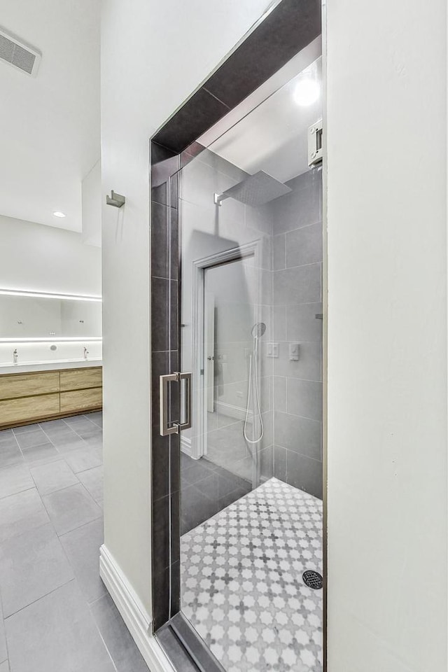 bathroom with a stall shower, tile patterned flooring, and visible vents