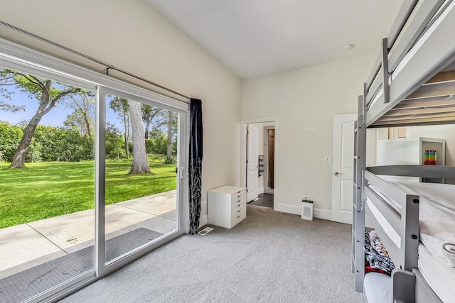 interior space with light carpet, access to exterior, baseboards, and lofted ceiling