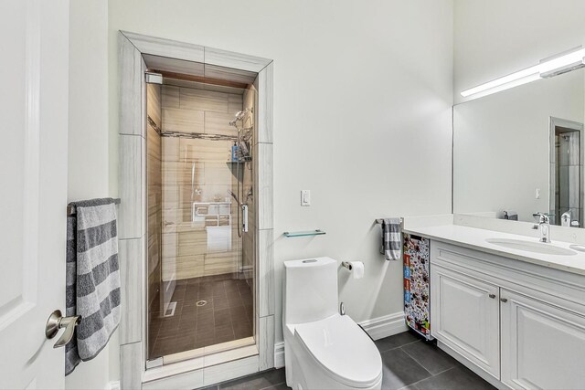 bathroom with vanity, baseboards, tile patterned floors, toilet, and a shower stall