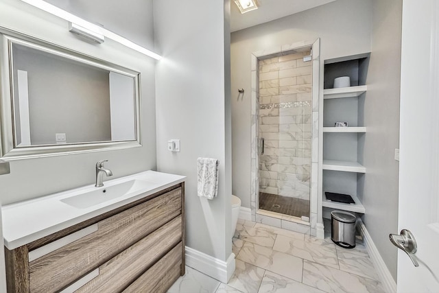 full bath with vanity, baseboards, a stall shower, toilet, and marble finish floor