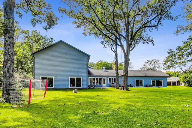 rear view of property with a yard