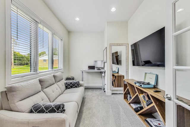 carpeted living area featuring baseboards and recessed lighting