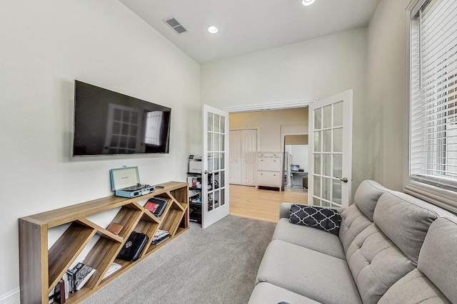 living area with french doors, carpet, visible vents, and recessed lighting